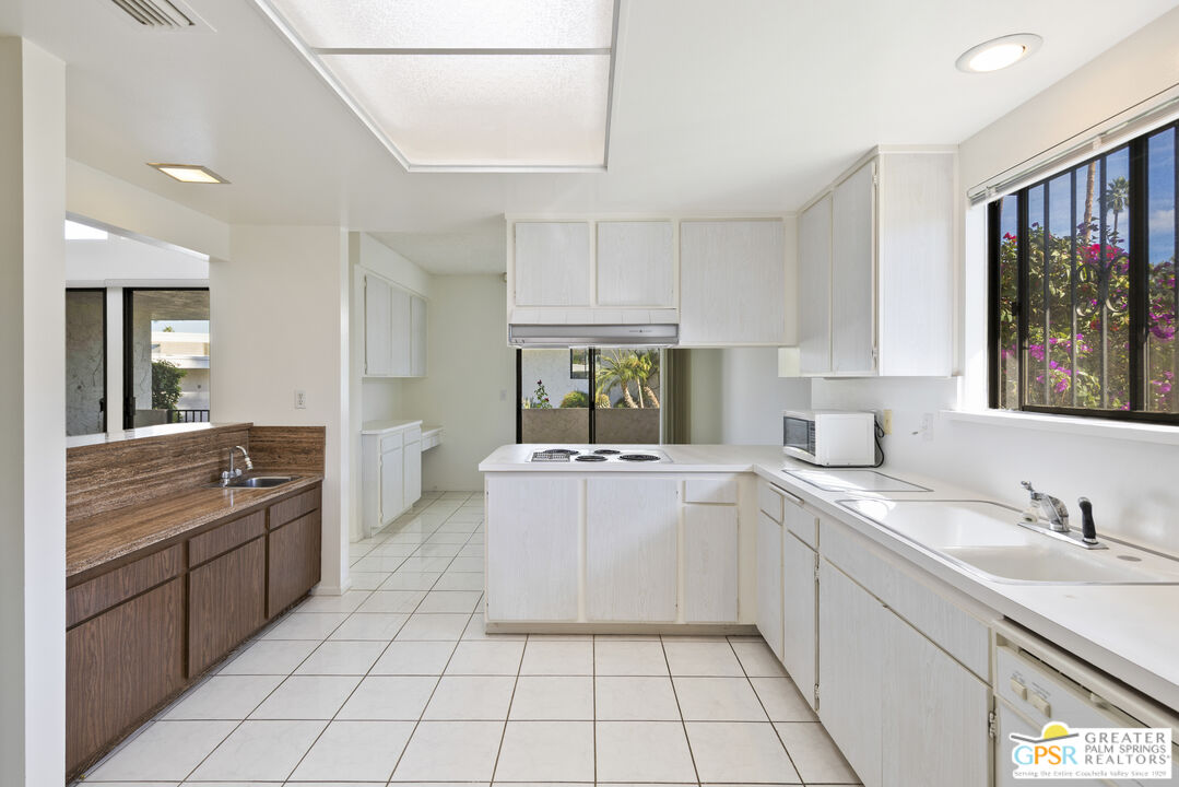 2296 Paseo Del Rey Palm Springs, CA 92264 - Photo 7 of 42 a kitchen with a sink and cabinets