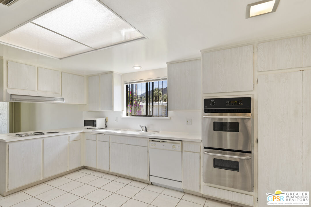 2296 Paseo Del Rey Palm Springs, CA 92264 - Photo 9 of 42 a kitchen with a sink and steel appliances