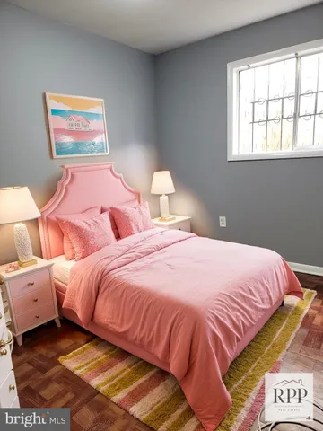 a bedroom with a bed and a painting on the wall
