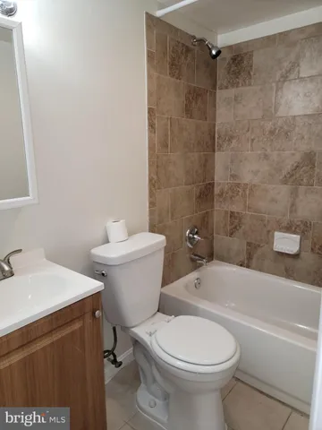 a white toilet sitting next to a bath tub
