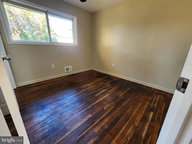 a room with wooden floors and window