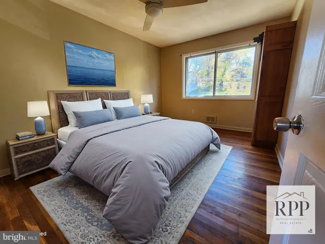 a large bed sitting in a bedroom next to a window