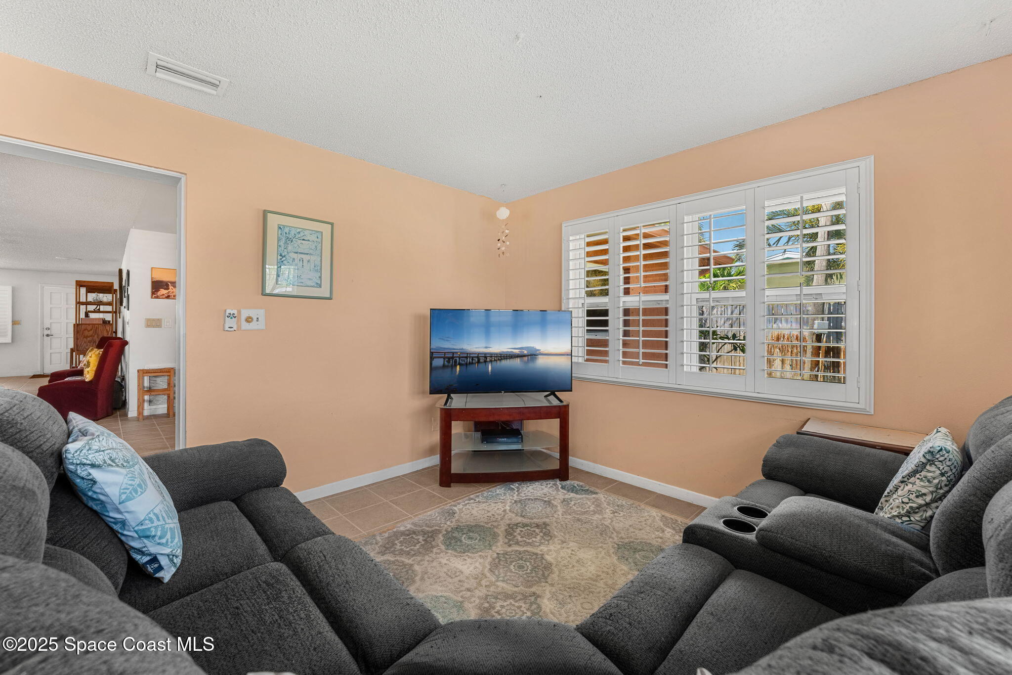 440 Pine Tree Drive Indialantic, FL 32903 - Photo 13 of 34 a living room with furniture and a window