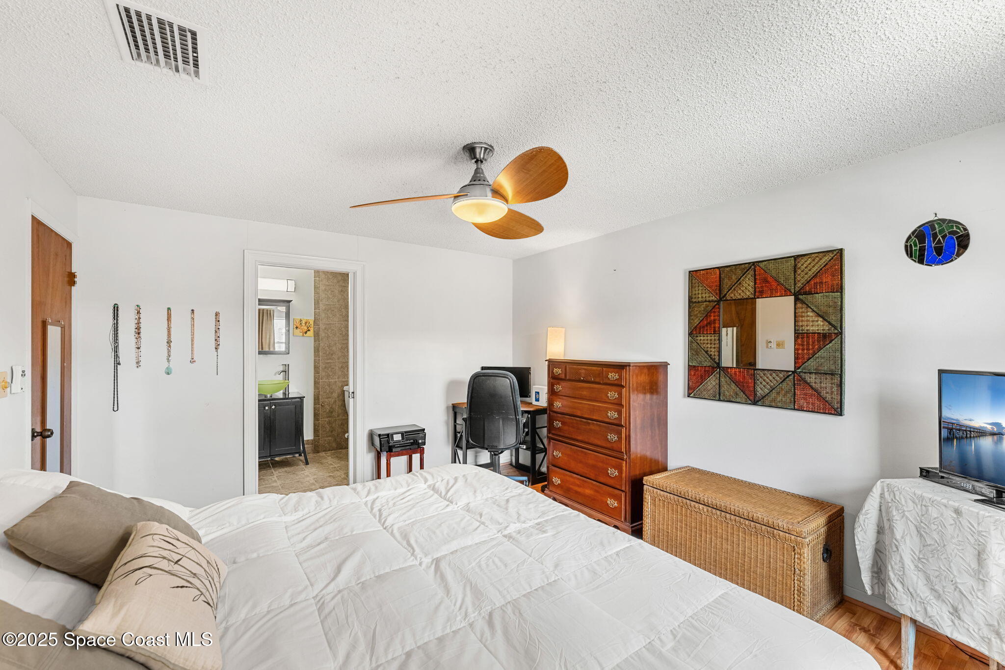 440 Pine Tree Drive Indialantic, FL 32903 - Photo 15 of 34 a bedroom with a bed and wooden floor