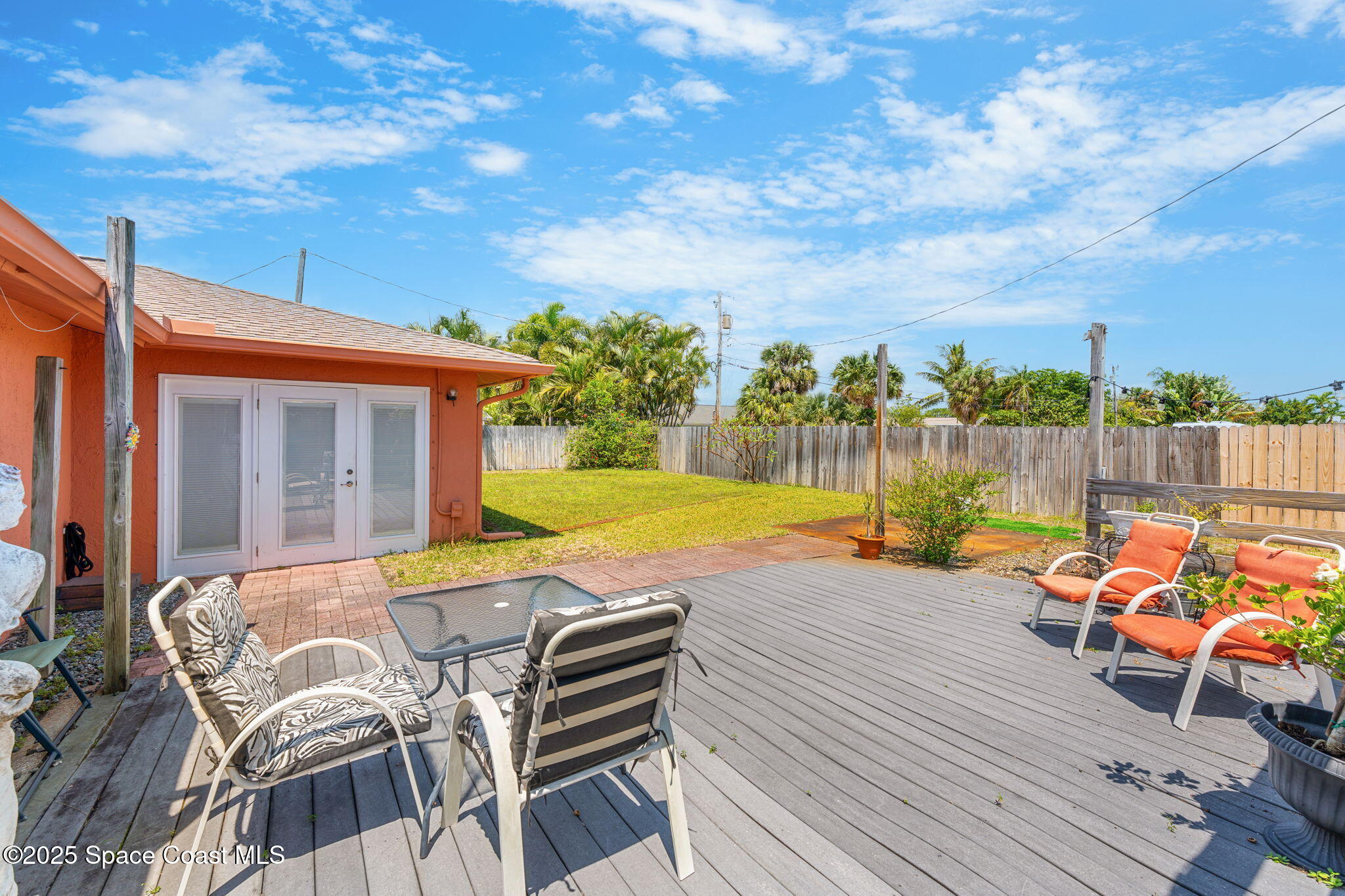 440 Pine Tree Drive Indialantic, FL 32903 - Photo 20 of 34 a view of a patio with table and chairs and wooden floor