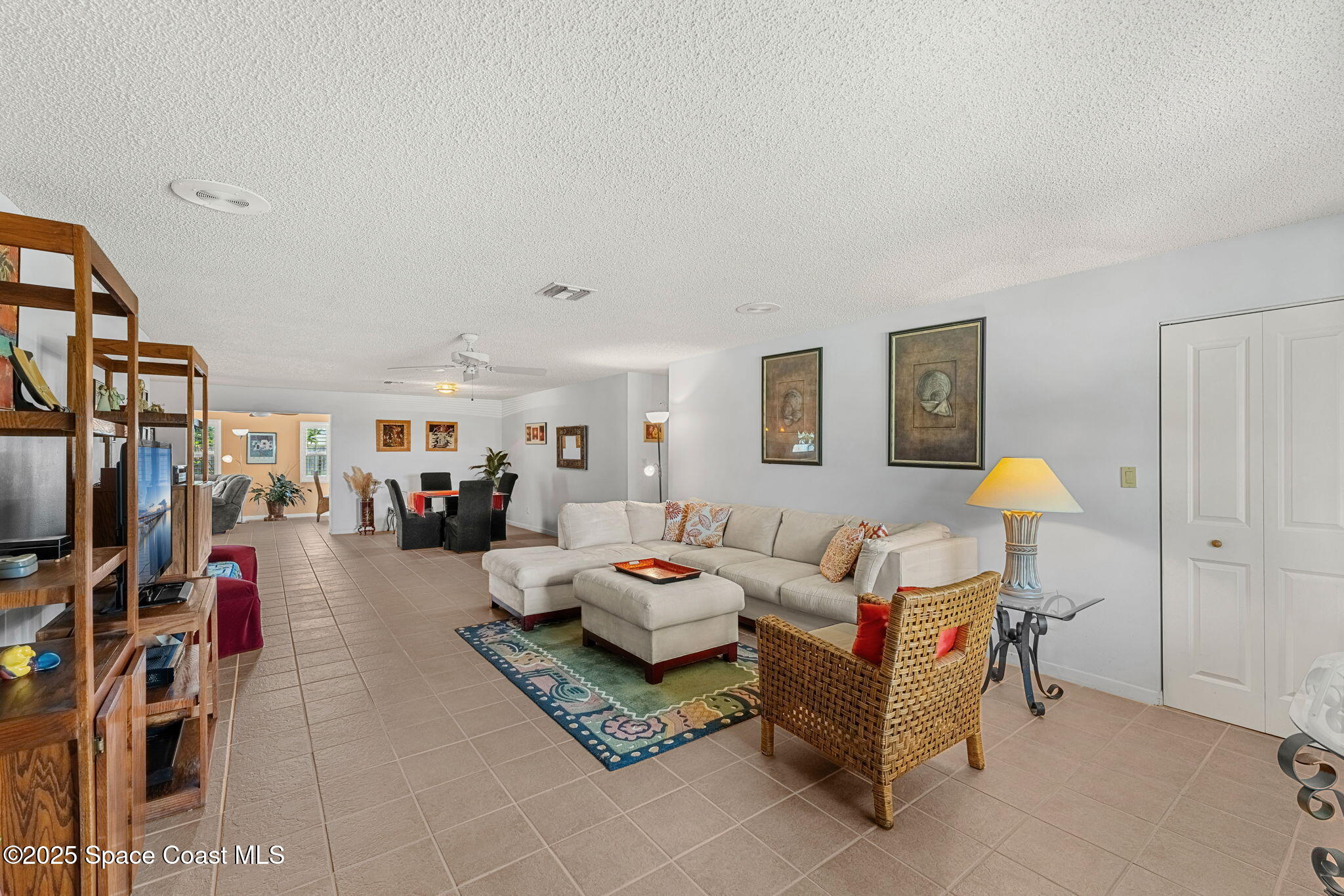440 Pine Tree Drive Indialantic, FL 32903 - Photo 4 of 34 a living room with furniture a couch and a bookshelf
