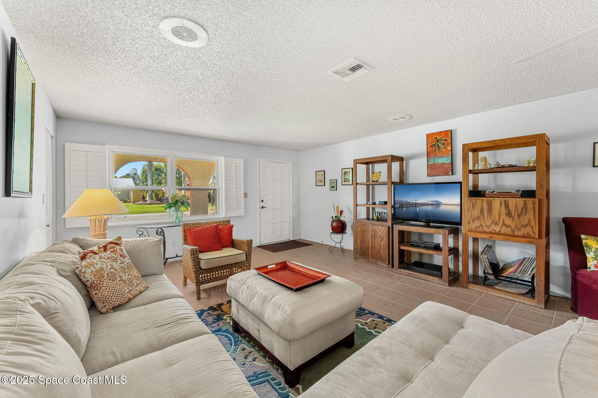 440 Pine Tree Drive Indialantic, FL 32903 - Photo 5 of 34 a living room with furniture and a flat screen tv