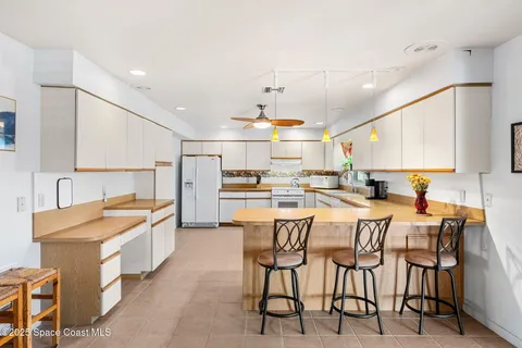 a large kitchen with a table and chairs