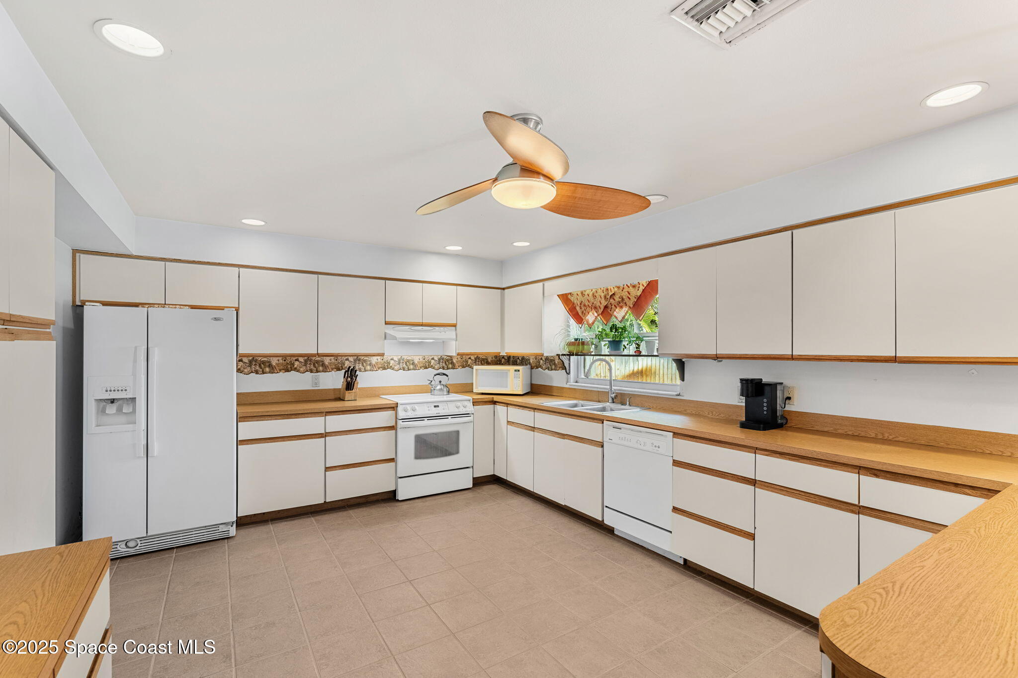 440 Pine Tree Drive Indialantic, FL 32903 - Photo 9 of 34 a kitchen that has a lot of cabinets in it and appliances