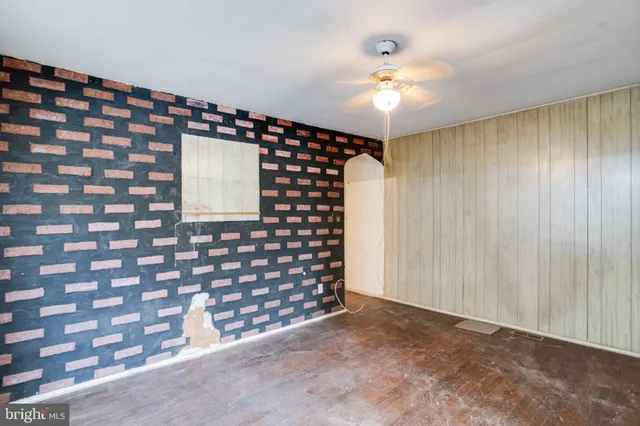 a very nice looking room with a large window and chandelier fan