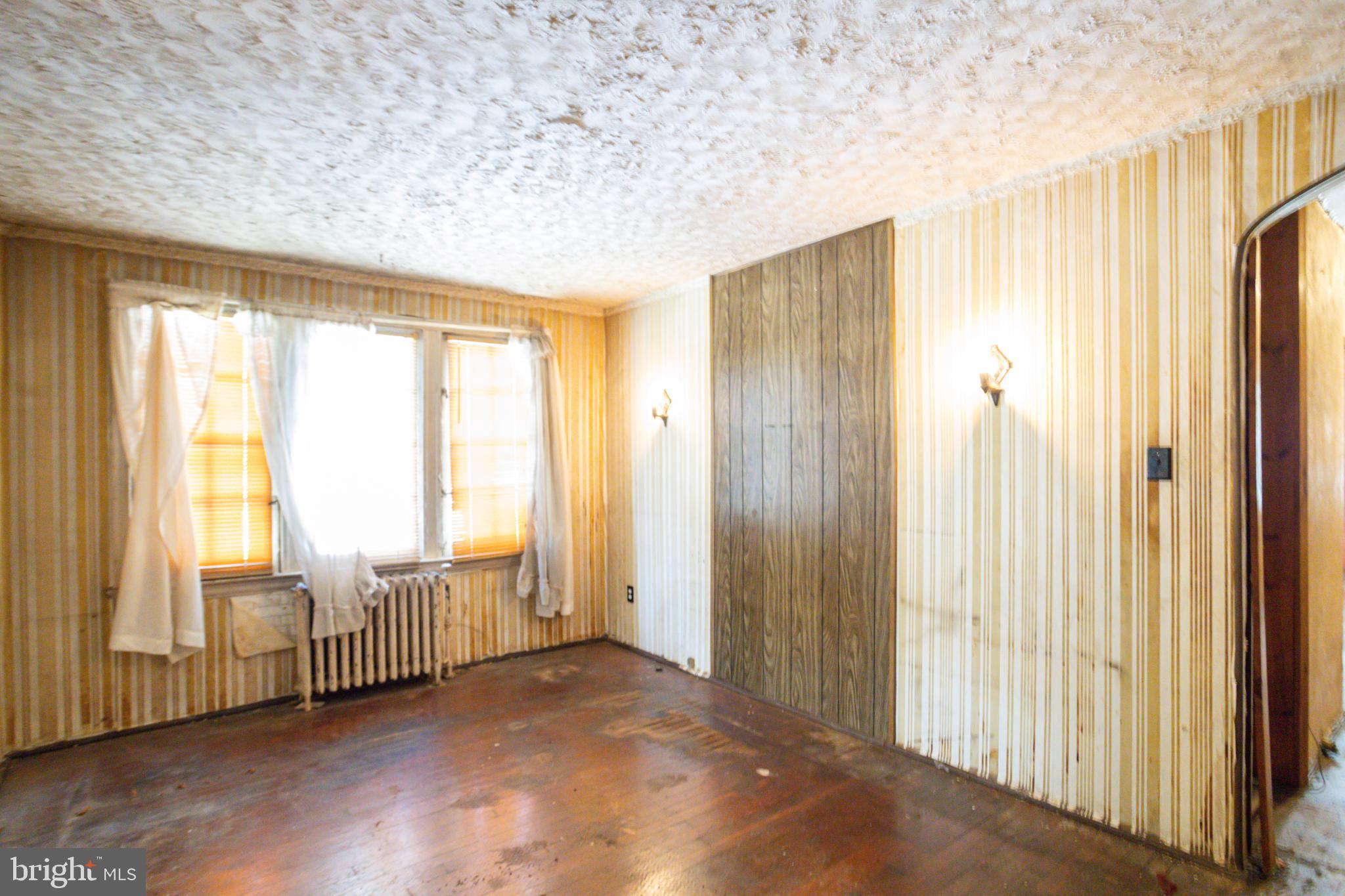 4209 Chatham Road Baltimore, MD 21207 - Photo 18 of 37 a view of an empty room with wooden floor and a window
