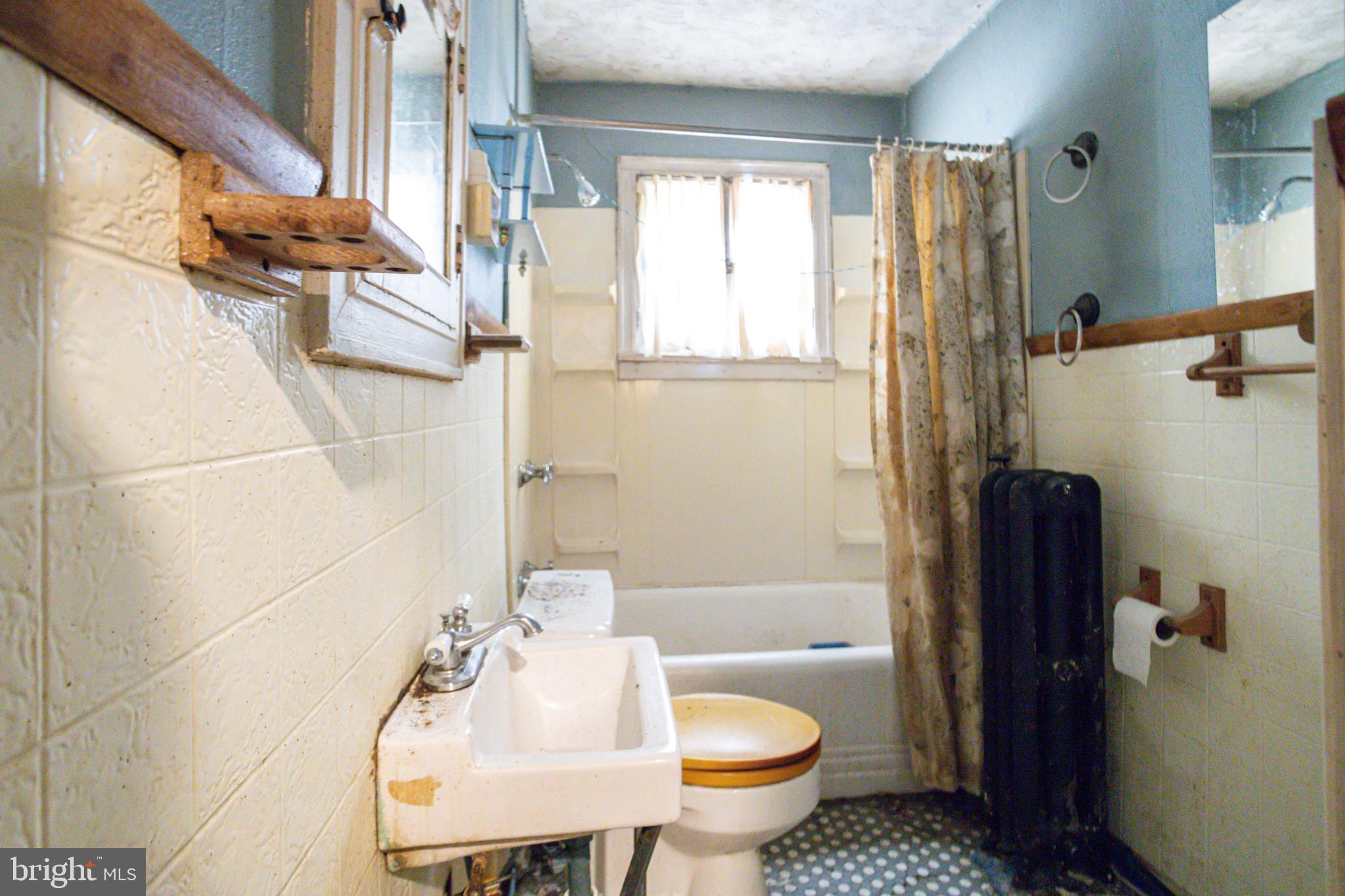 4209 Chatham Road Baltimore, MD 21207 - Photo 20 of 37 a bathroom with a sink toilet and shower
