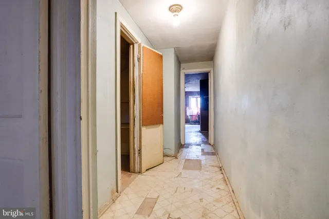a view of a hallway with wooden shelves