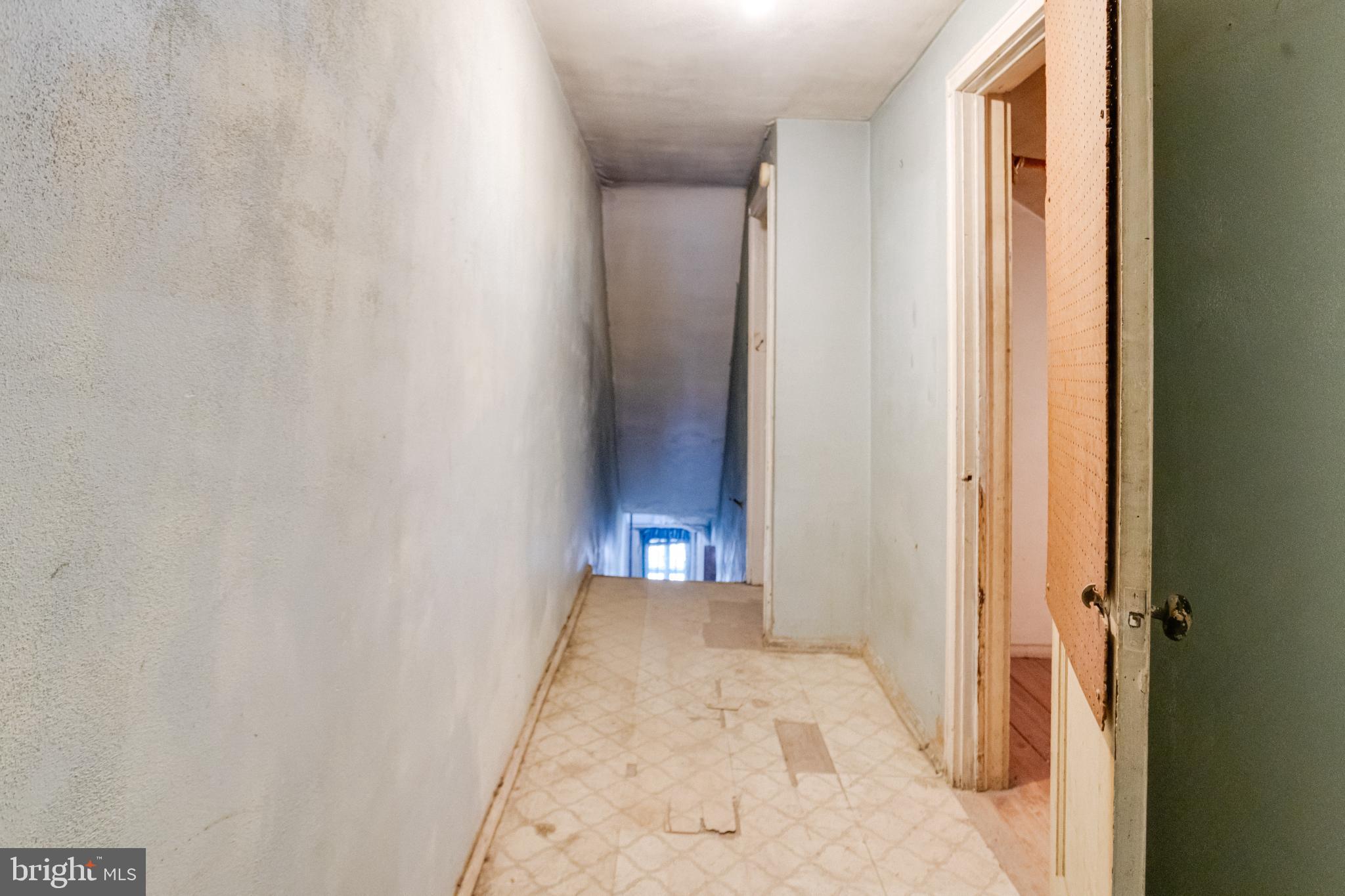4209 Chatham Road Baltimore, MD 21207 - Photo 31 of 37 a view of a hallway with wooden floor and a bathroom