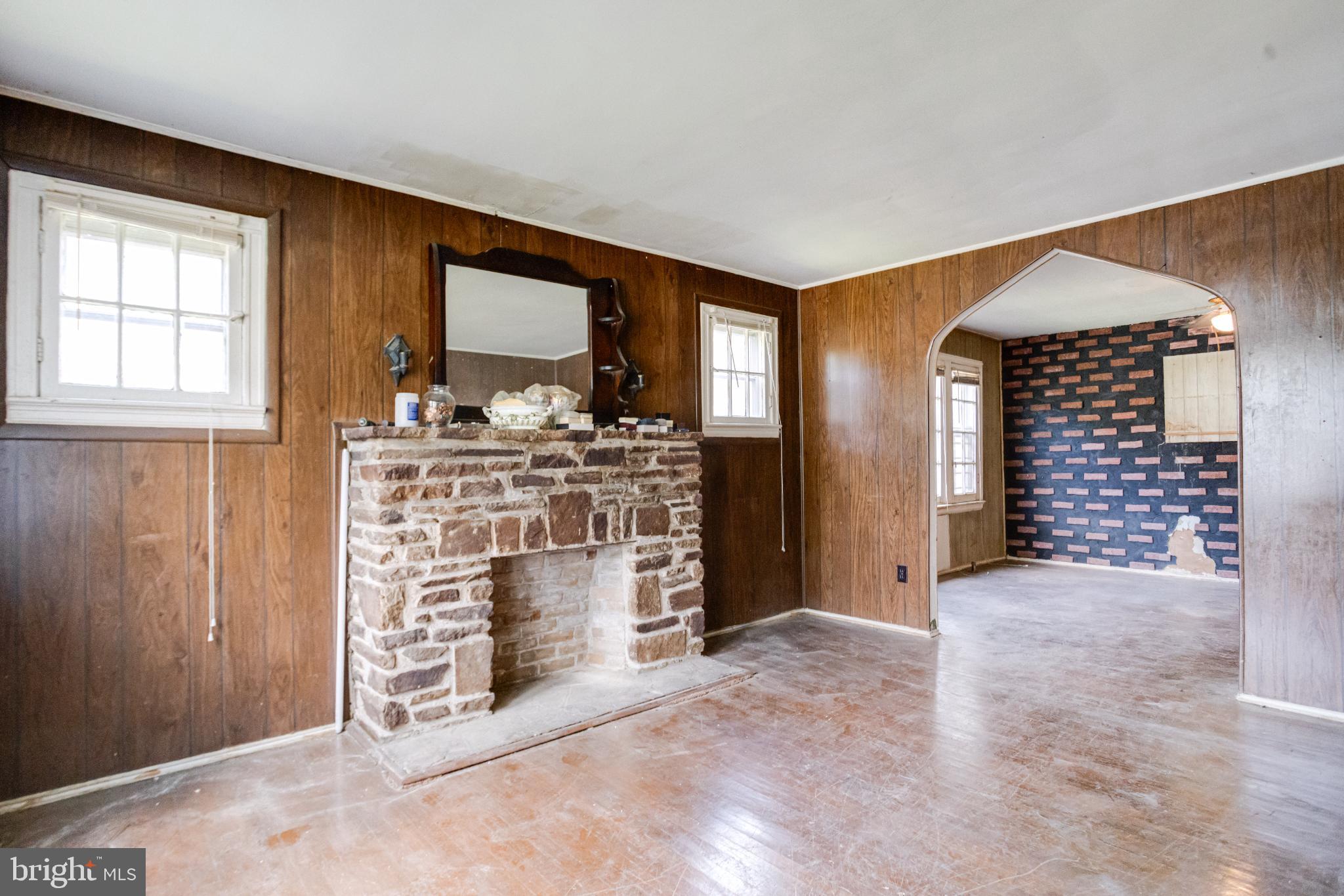 4209 Chatham Road Baltimore, MD 21207 - Photo 33 of 37 an empty room with fireplace and windows