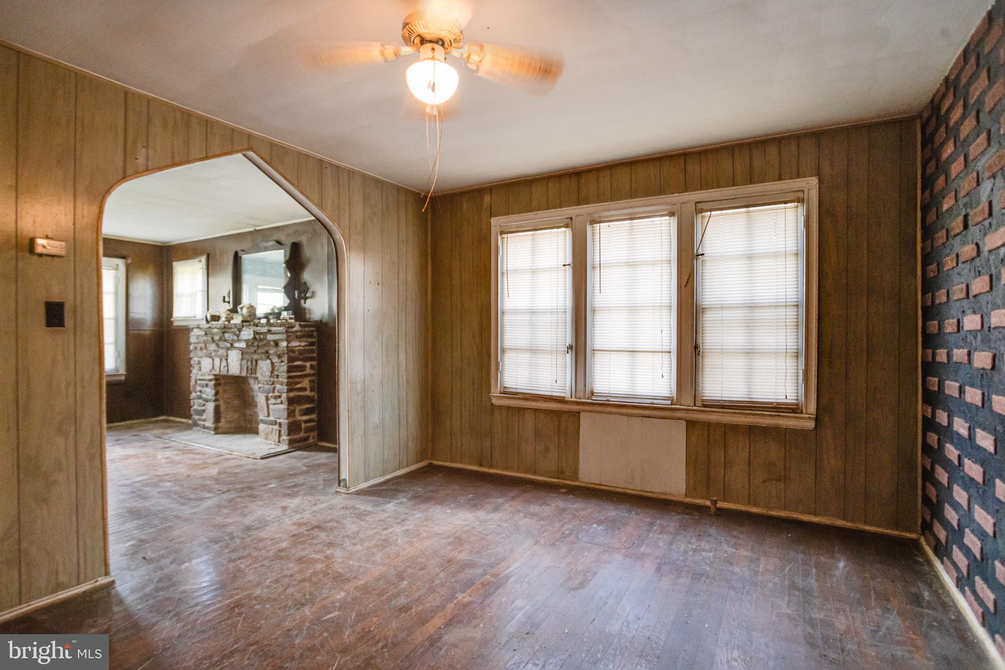 4209 Chatham Road Baltimore, MD 21207 - Photo 9 of 37 an empty room with chandelier fan and windows