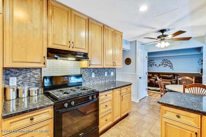 48 Peachstone Road Howell, NJ 07731 - Photo 9 of 24 a kitchen with stainless steel appliances granite countertop a stove a sink and a microwave