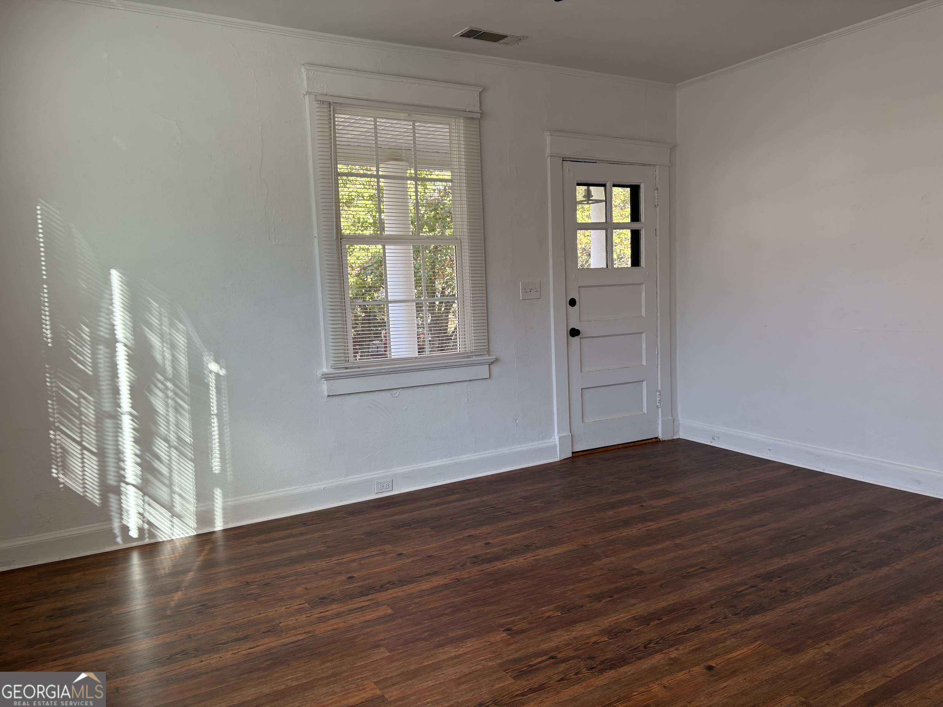 119 S Street Northwest Thomaston, GA 30286 - Photo 22 of 31 a view of an empty room with wooden floor and a window