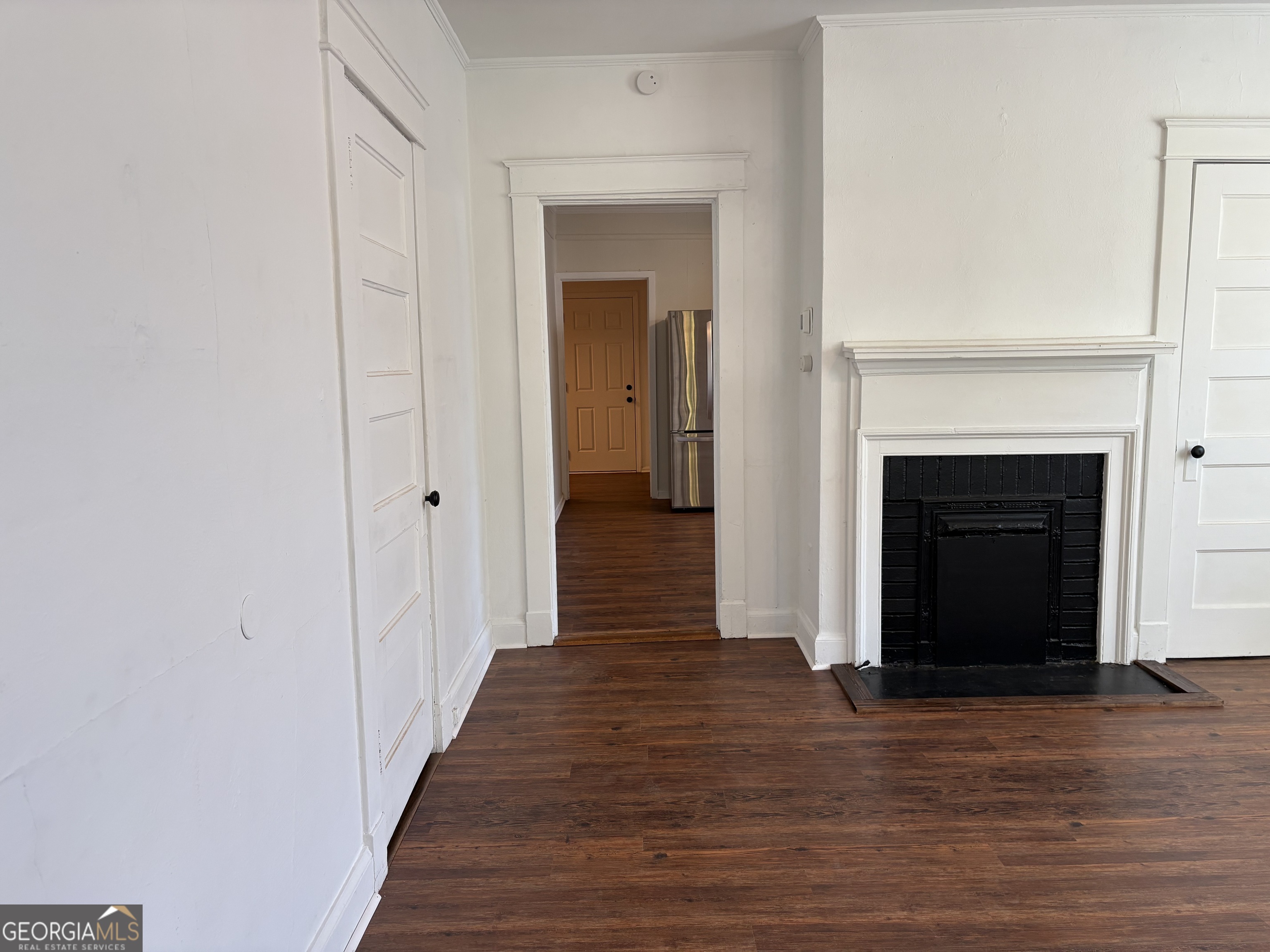 119 S Street Northwest Thomaston, GA 30286 - Photo 23 of 31 a view of a hallway with wooden floor and a fireplace
