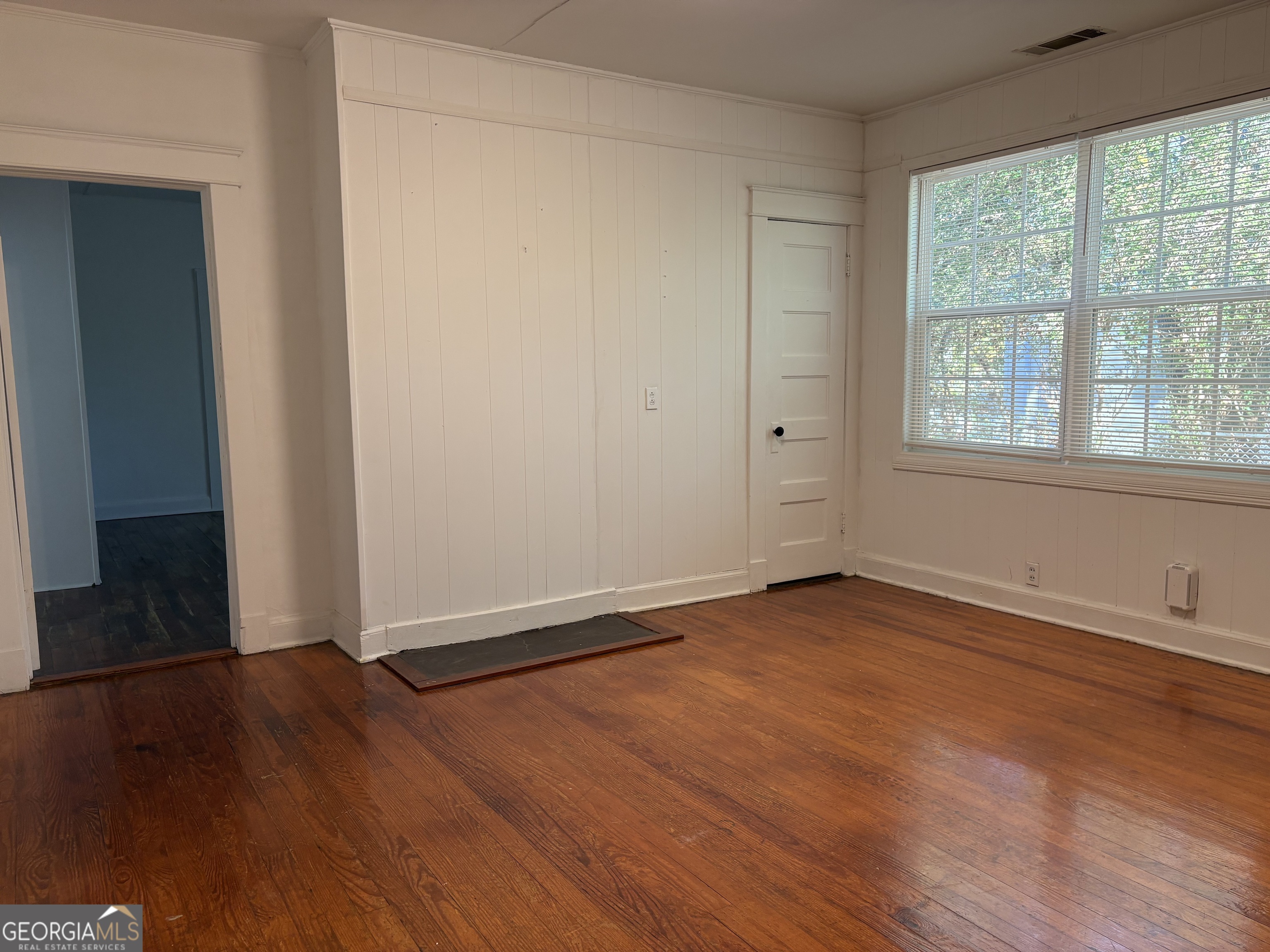 119 S Street Northwest Thomaston, GA 30286 - Photo 29 of 31 an empty room with wooden floor and windows