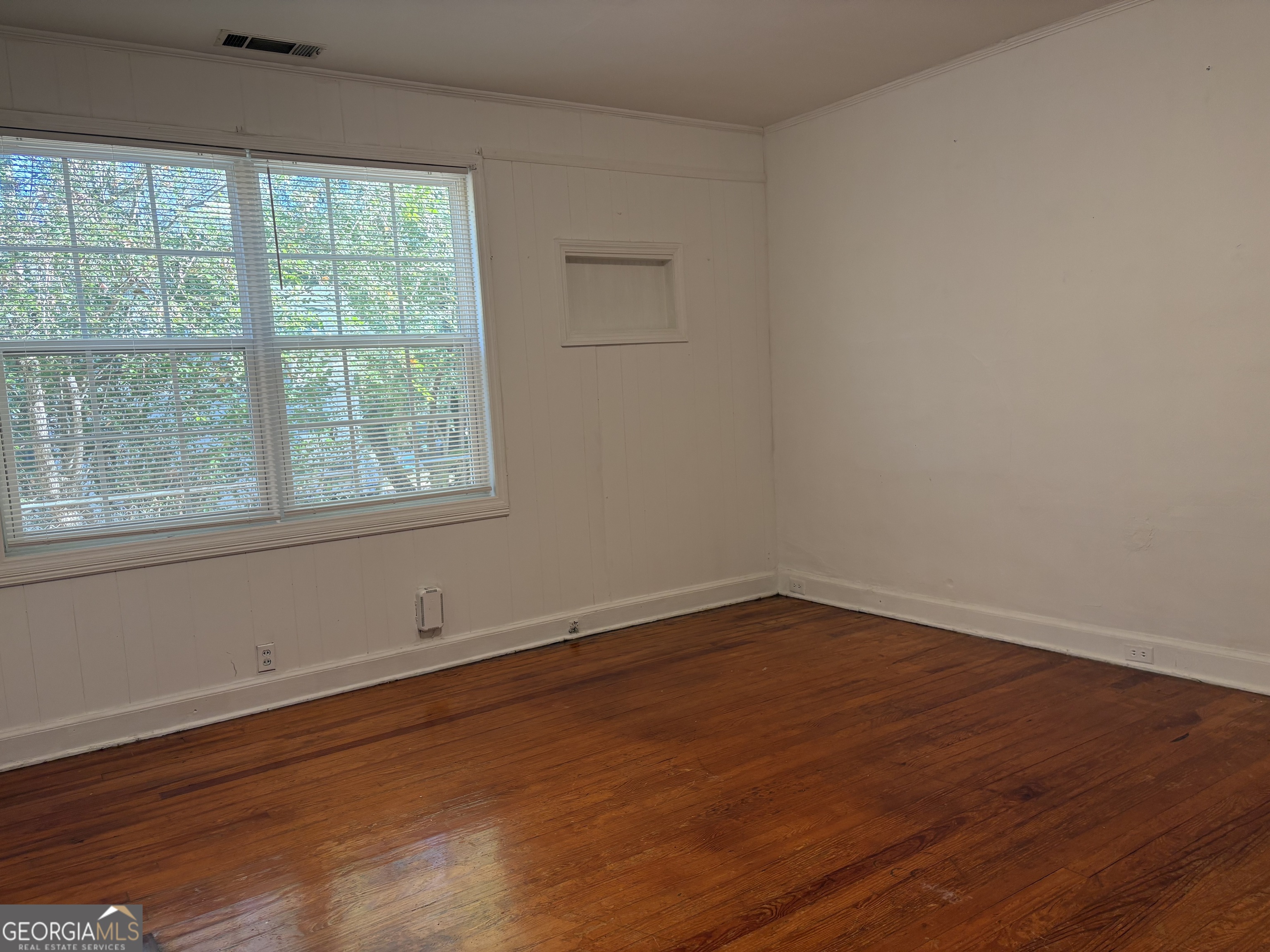 119 S Street Northwest Thomaston, GA 30286 - Photo 30 of 31 an empty room with wooden floor and windows