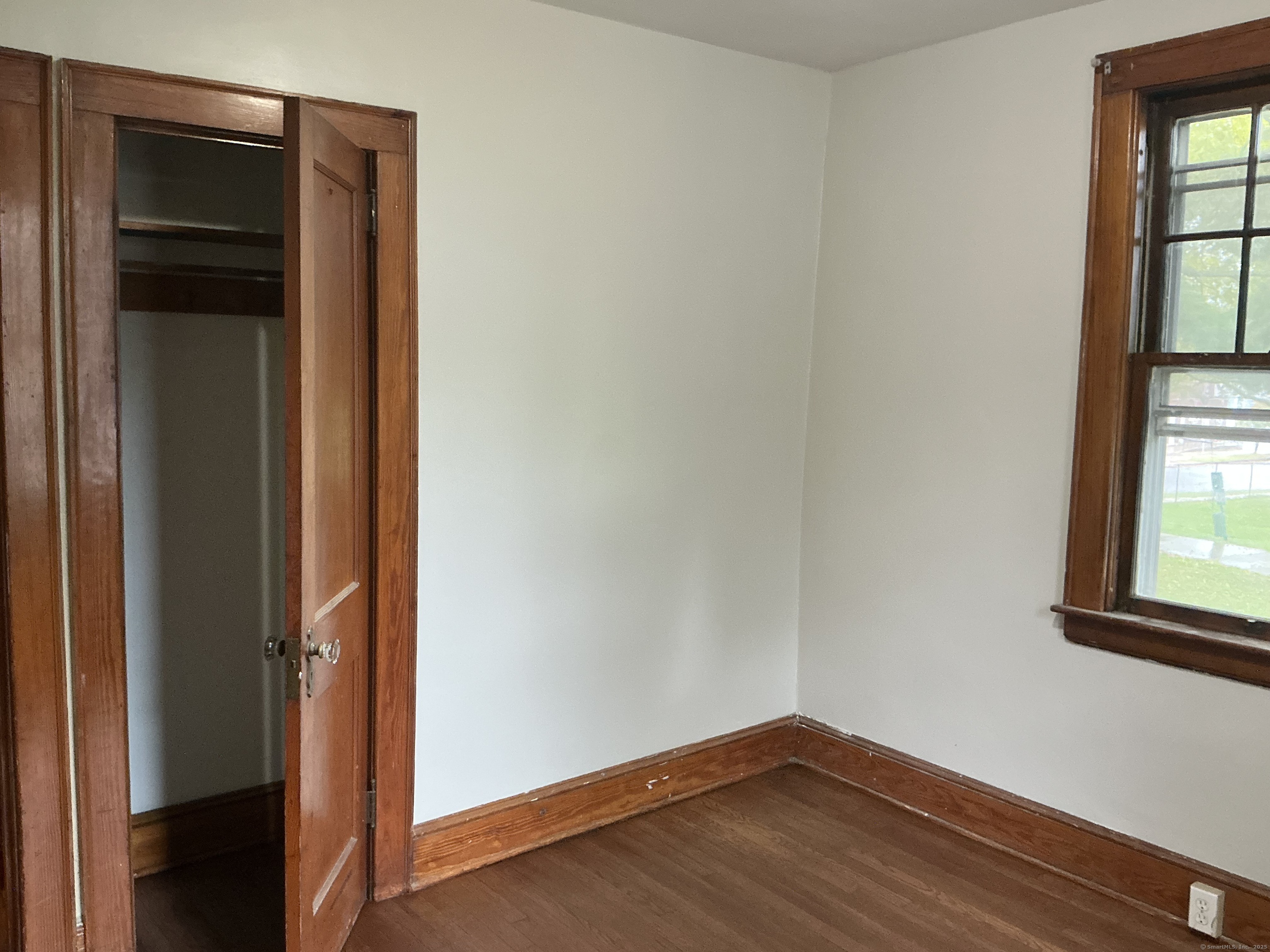 73 Stack Street Middletown, CT 06457 - Photo 12 of 18 a view of an empty room with wooden floor and a window