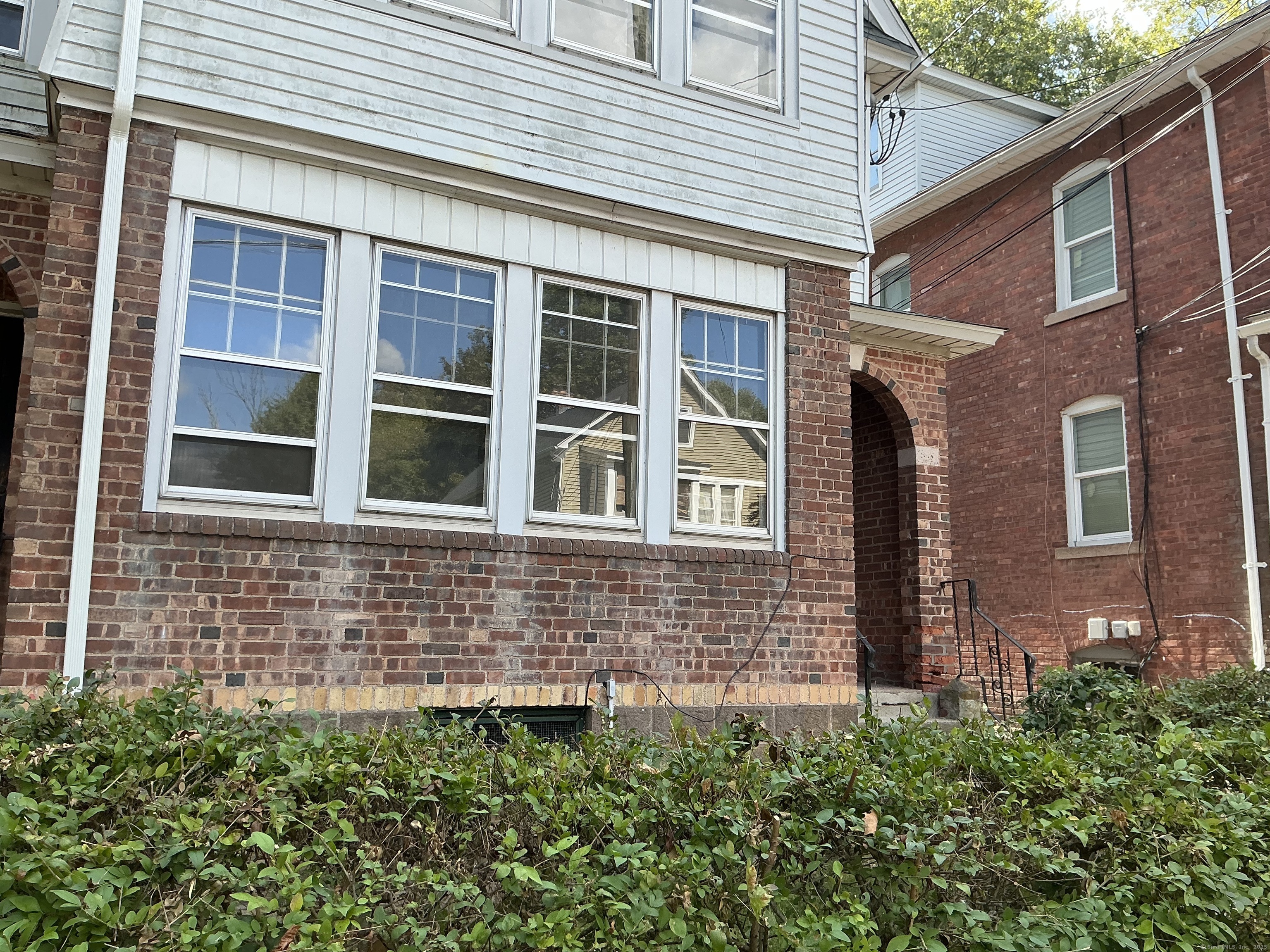 73 Stack Street Middletown, CT 06457 - Photo 18 of 18 a view of a brick house with a large windows and a potted plant