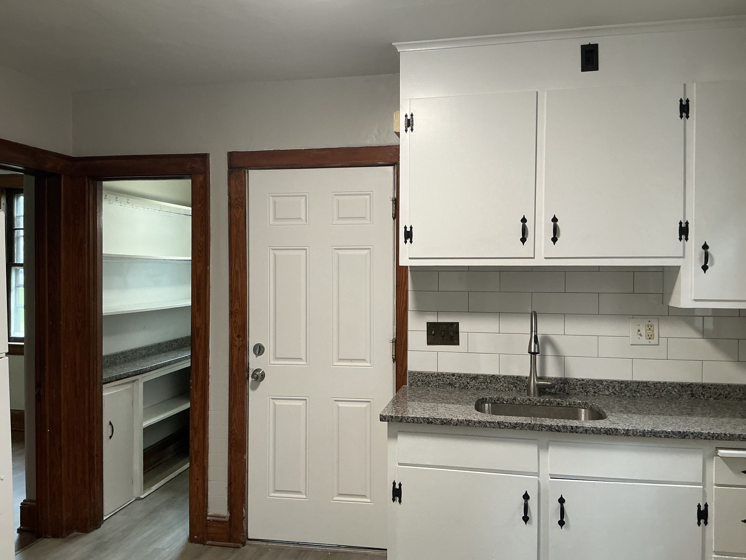 73 Stack Street Middletown, CT 06457 - Photo 3 of 18 a kitchen with granite countertop white cabinets and white appliances