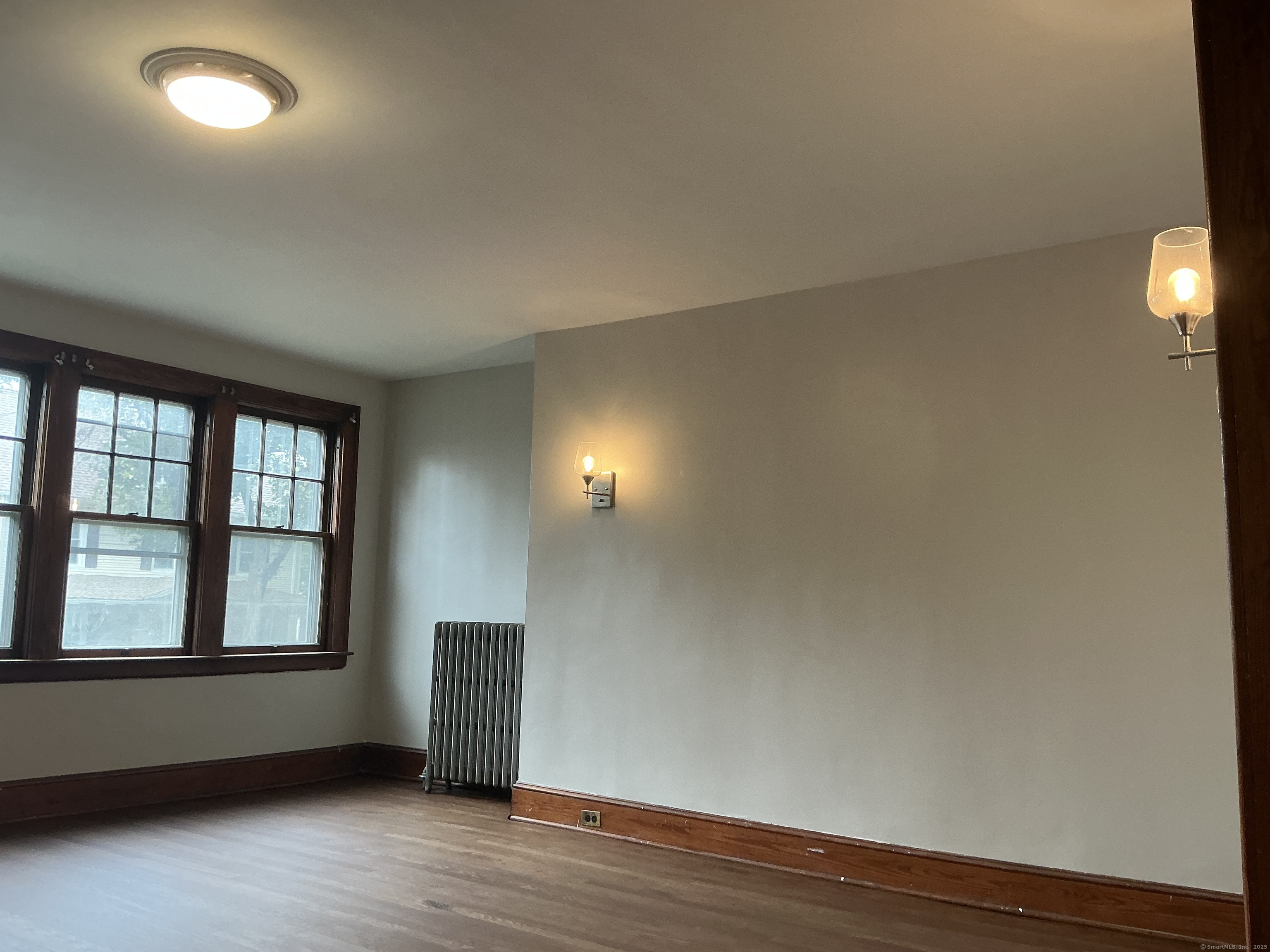 73 Stack Street Middletown, CT 06457 - Photo 10 of 18 an empty room with wooden floor and windows