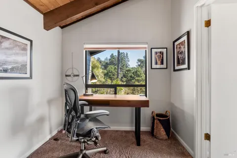 a bedroom with furniture and large window