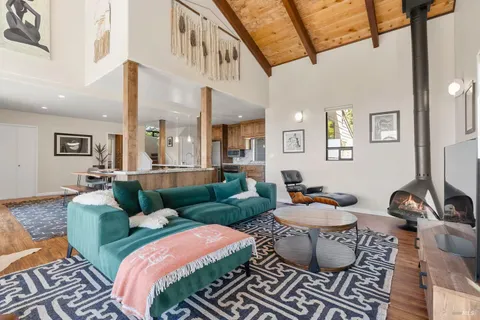 a living room with furniture a rug and a large window