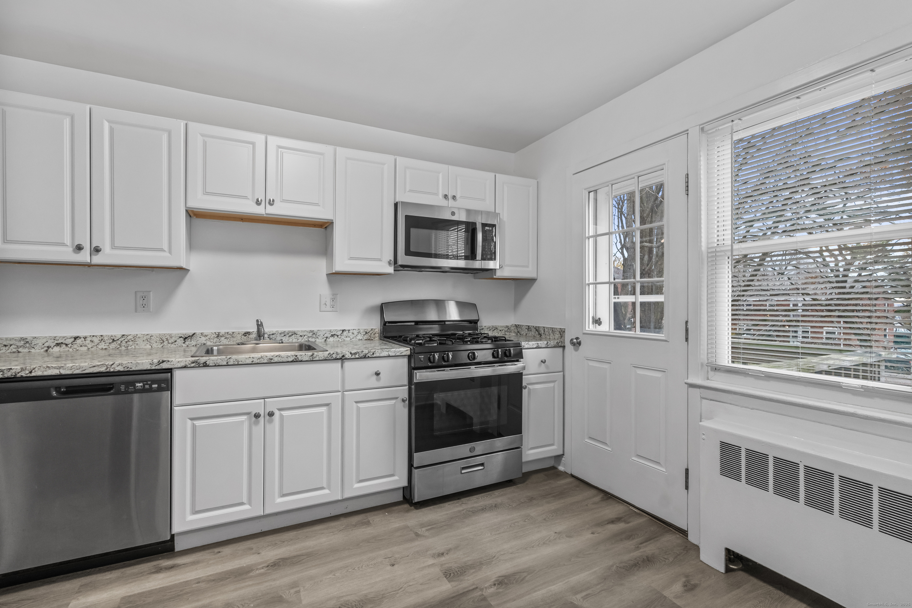 a kitchen with stainless steel appliances granite countertop a stove and a sink