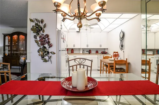 a view of a dining room with furniture and chandelier