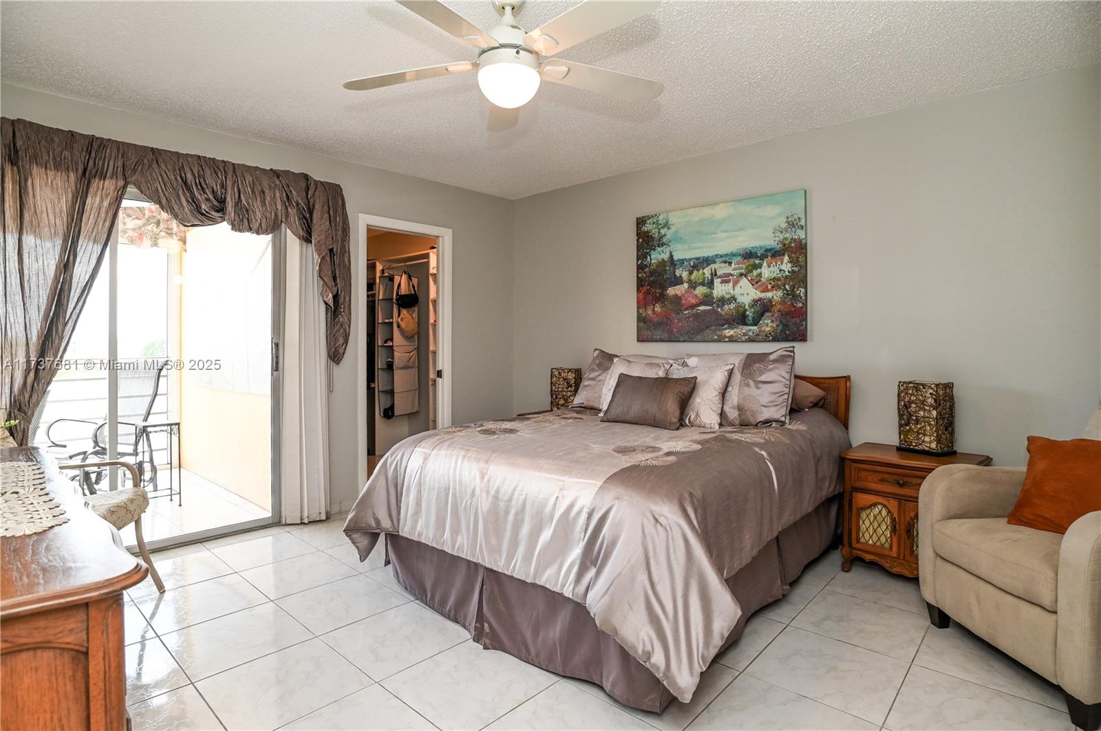 4110 Oakridge V, Unit 4110 Deerfield Beach, FL 33442 - Photo 18 of 63 a bedroom with a large bed and a window
