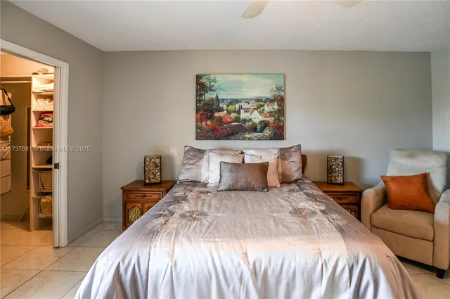 a bedroom with a bed and a painting on the wall