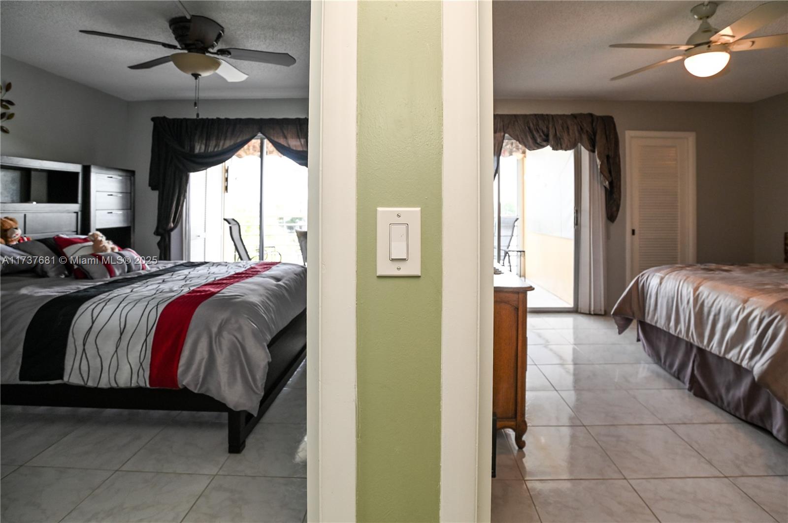4110 Oakridge V, Unit 4110 Deerfield Beach, FL 33442 - Photo 25 of 63 a spacious bedroom with a bed and a chandelier