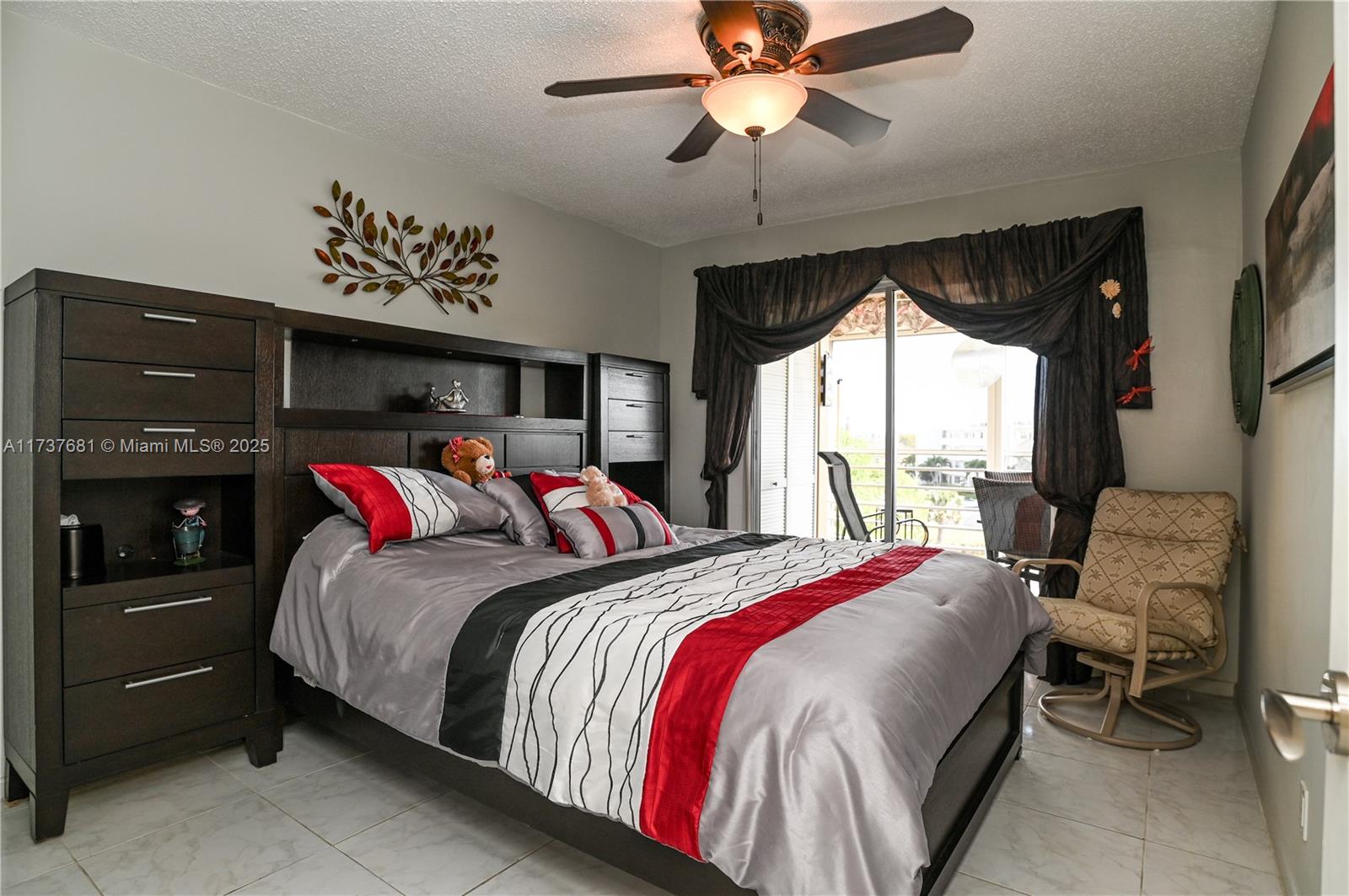 4110 Oakridge V, Unit 4110 Deerfield Beach, FL 33442 - Photo 26 of 63 a bed room with a bed and a chandelier