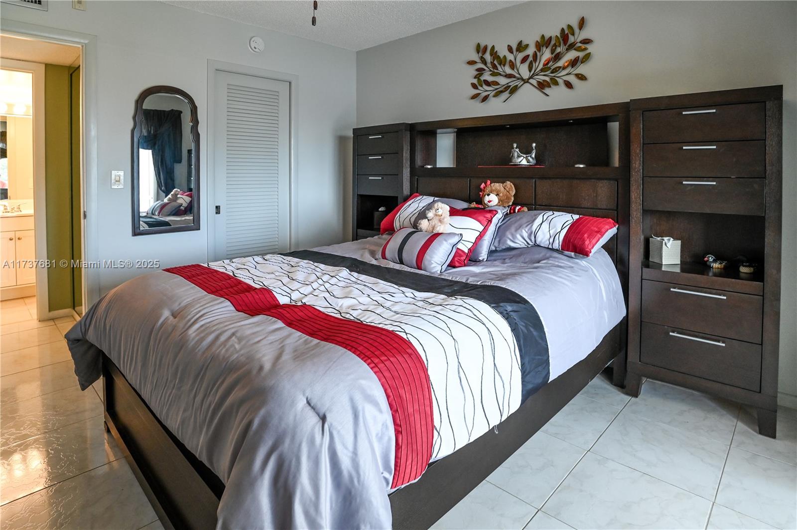 4110 Oakridge V, Unit 4110 Deerfield Beach, FL 33442 - Photo 28 of 63 a bedroom with a bed and a closet