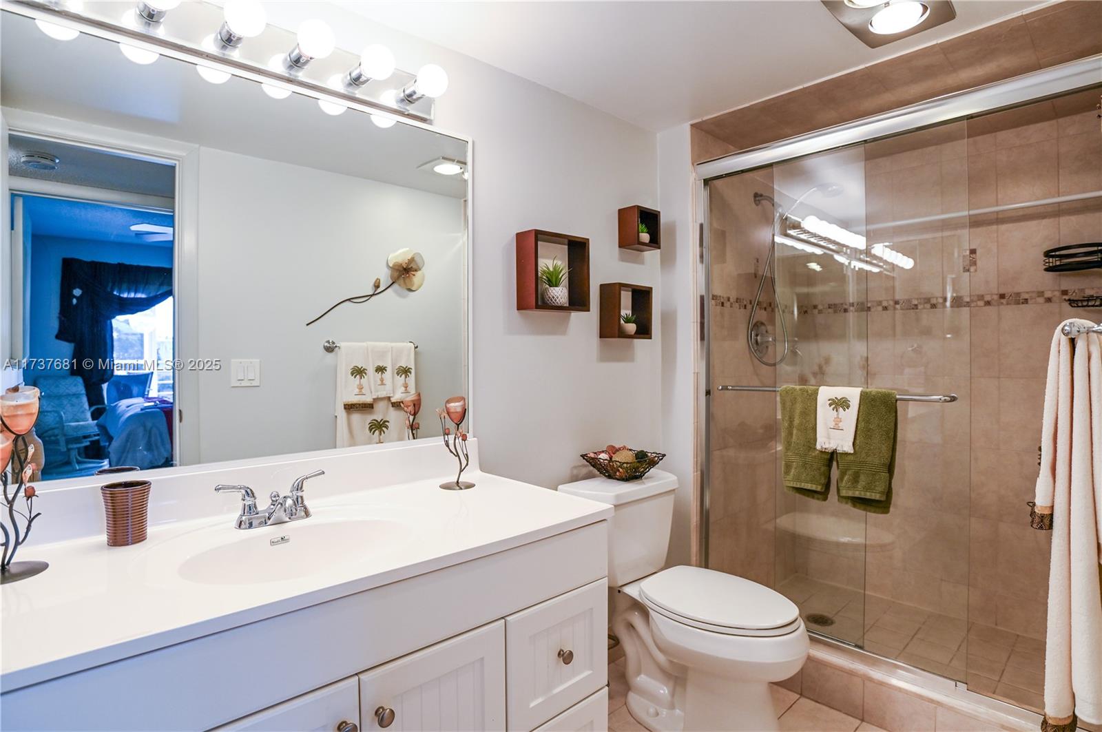 4110 Oakridge V, Unit 4110 Deerfield Beach, FL 33442 - Photo 31 of 63 a bathroom with a sink a toilet and shower