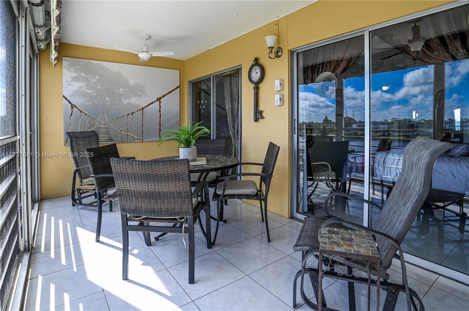 4110 Oakridge V, Unit 4110 Deerfield Beach, FL 33442 - Photo 37 of 63 a view of a patio with a dining table and chairs