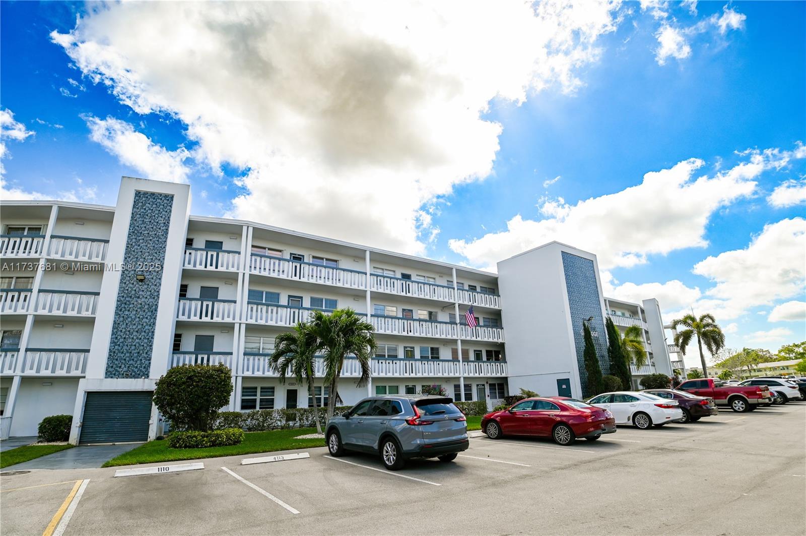 4110 Oakridge V, Unit 4110 Deerfield Beach, FL 33442 - Photo 50 of 63 a buildings with car parked in front of it