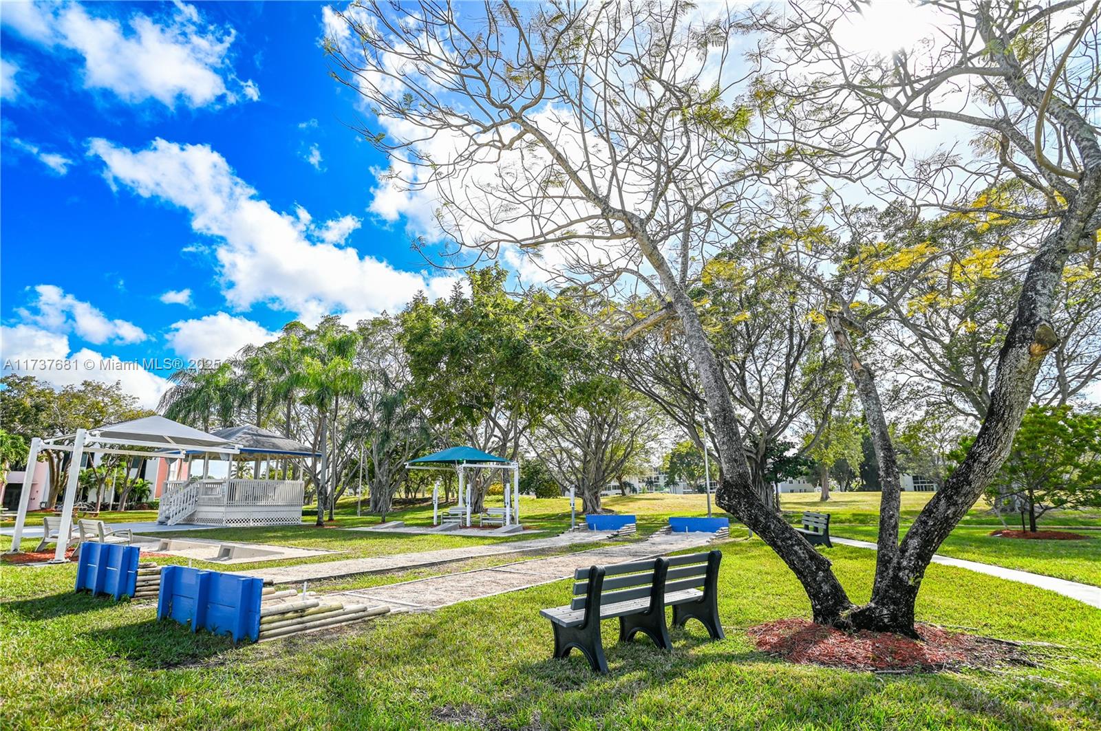 4110 Oakridge V, Unit 4110 Deerfield Beach, FL 33442 - Photo 53 of 63 a house view with a sitting space and garden view
