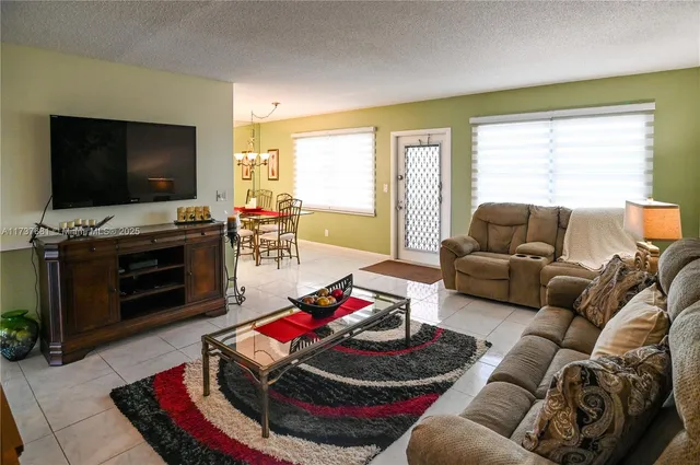 a living room with furniture fireplace and flat screen tv