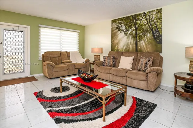 a living room with furniture and a rug