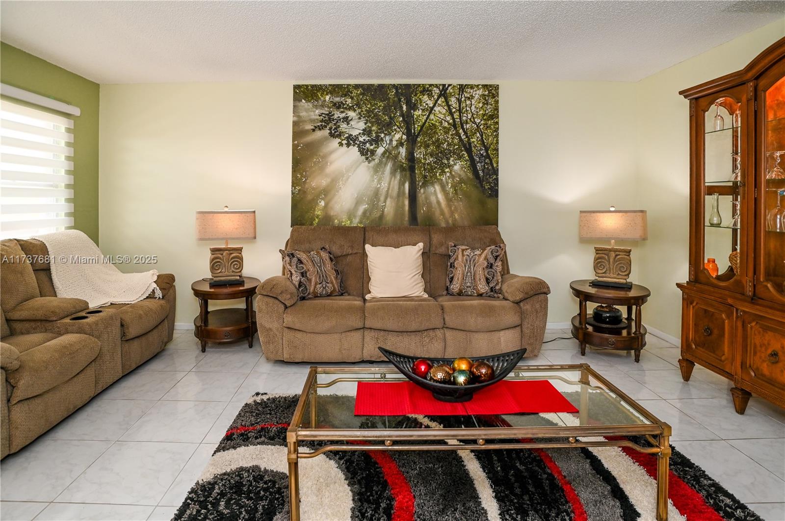 4110 Oakridge V, Unit 4110 Deerfield Beach, FL 33442 - Photo 9 of 63 a living room with furniture and a lamp