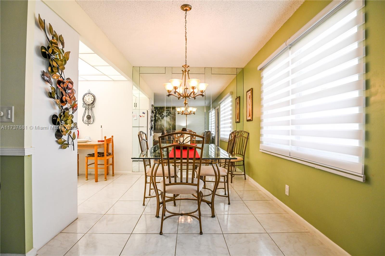 4110 Oakridge V, Unit 4110 Deerfield Beach, FL 33442 - Photo 10 of 63 a dining room with furniture and window
