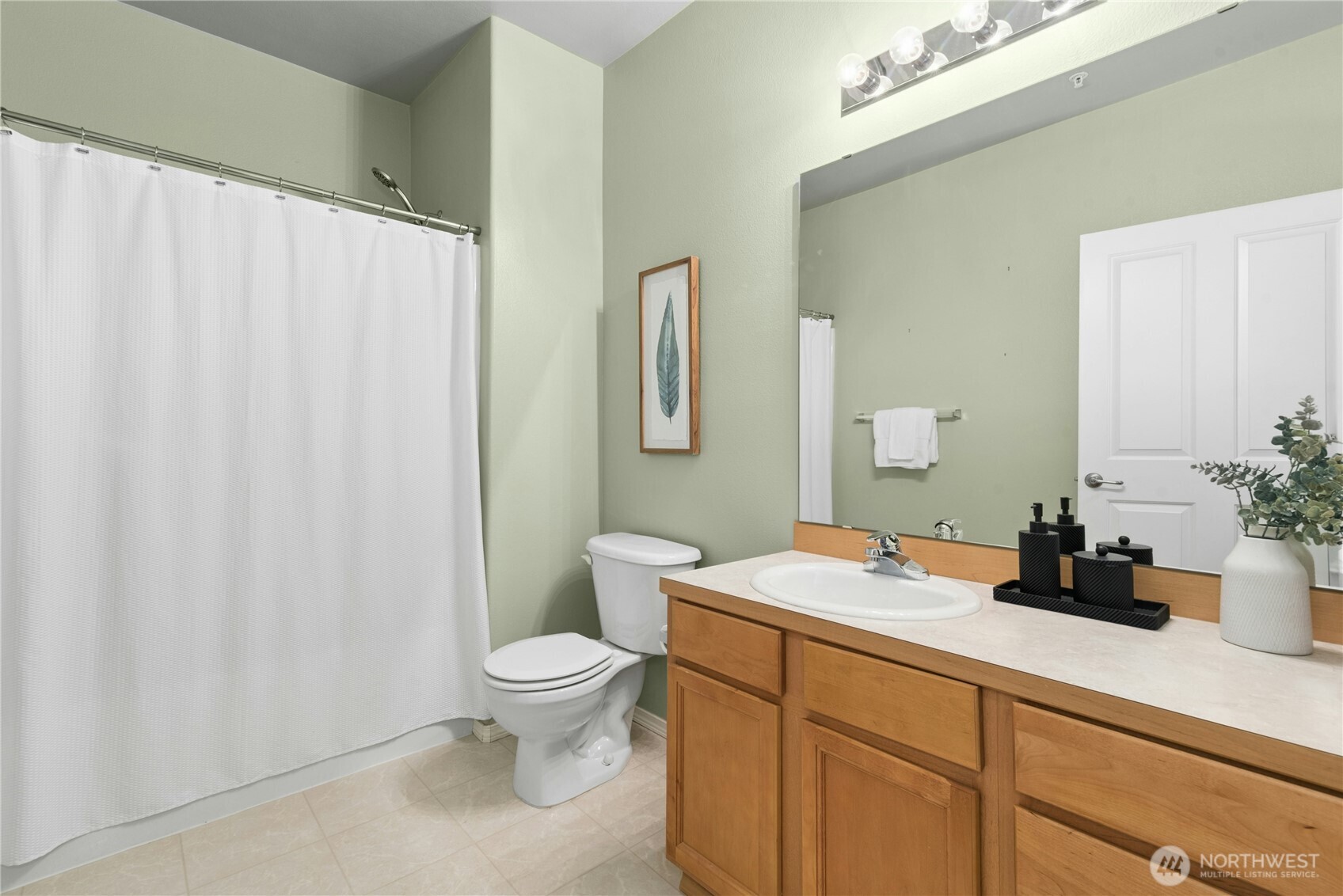 14915 38th Drive Southeast, Unit II1033 Bothell, WA 98012 - Photo 14 of 25 a bathroom with a sink a toilet and a mirror