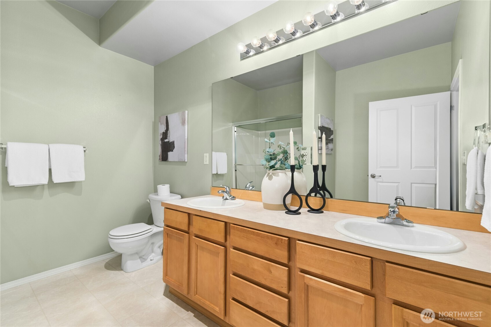 14915 38th Drive Southeast, Unit II1033 Bothell, WA 98012 - Photo 15 of 25 a bathroom with a toilet a sink and mirror