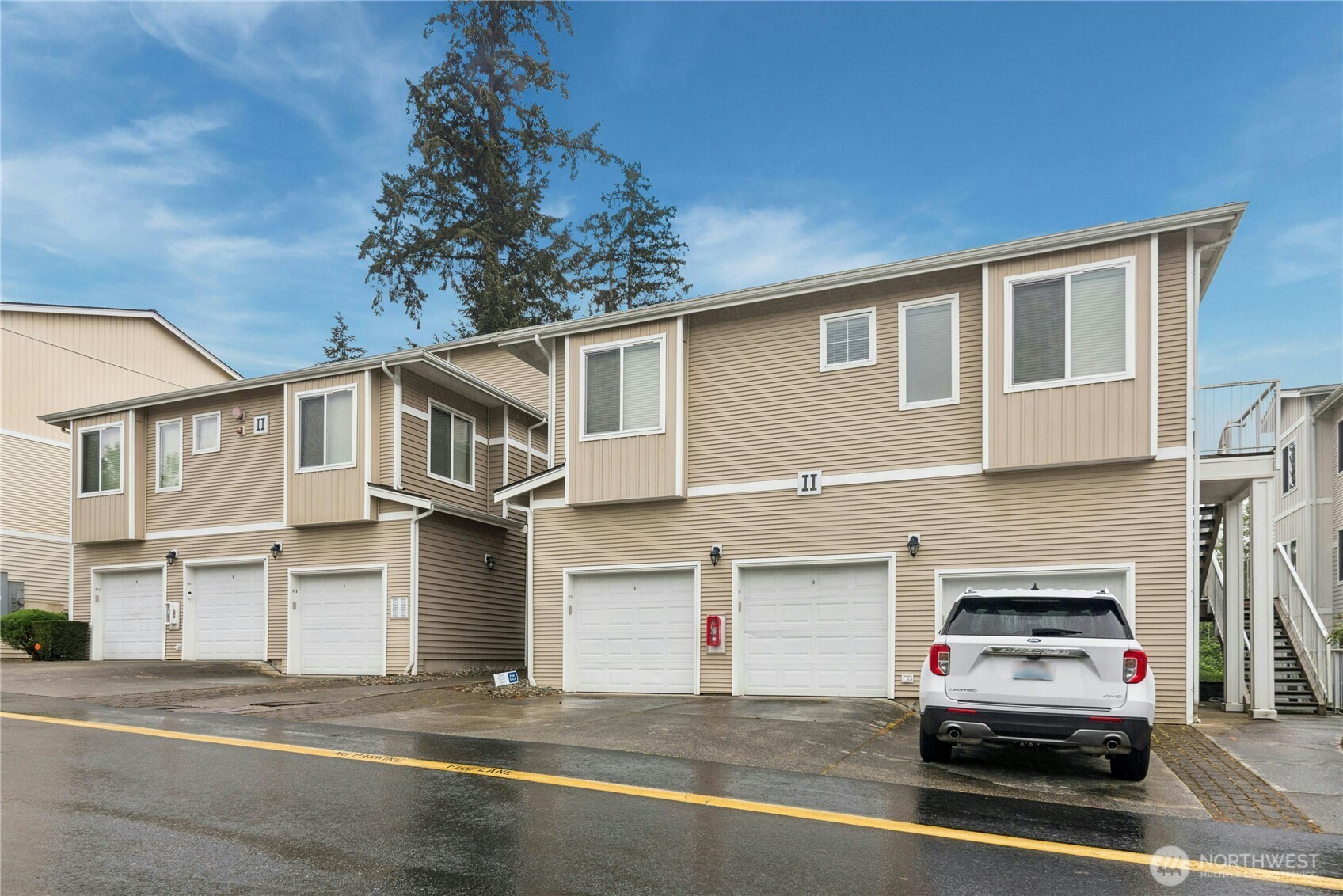 14915 38th Drive Southeast, Unit II1033 Bothell, WA 98012 - Photo 24 of 25 a car parked in front of a white house