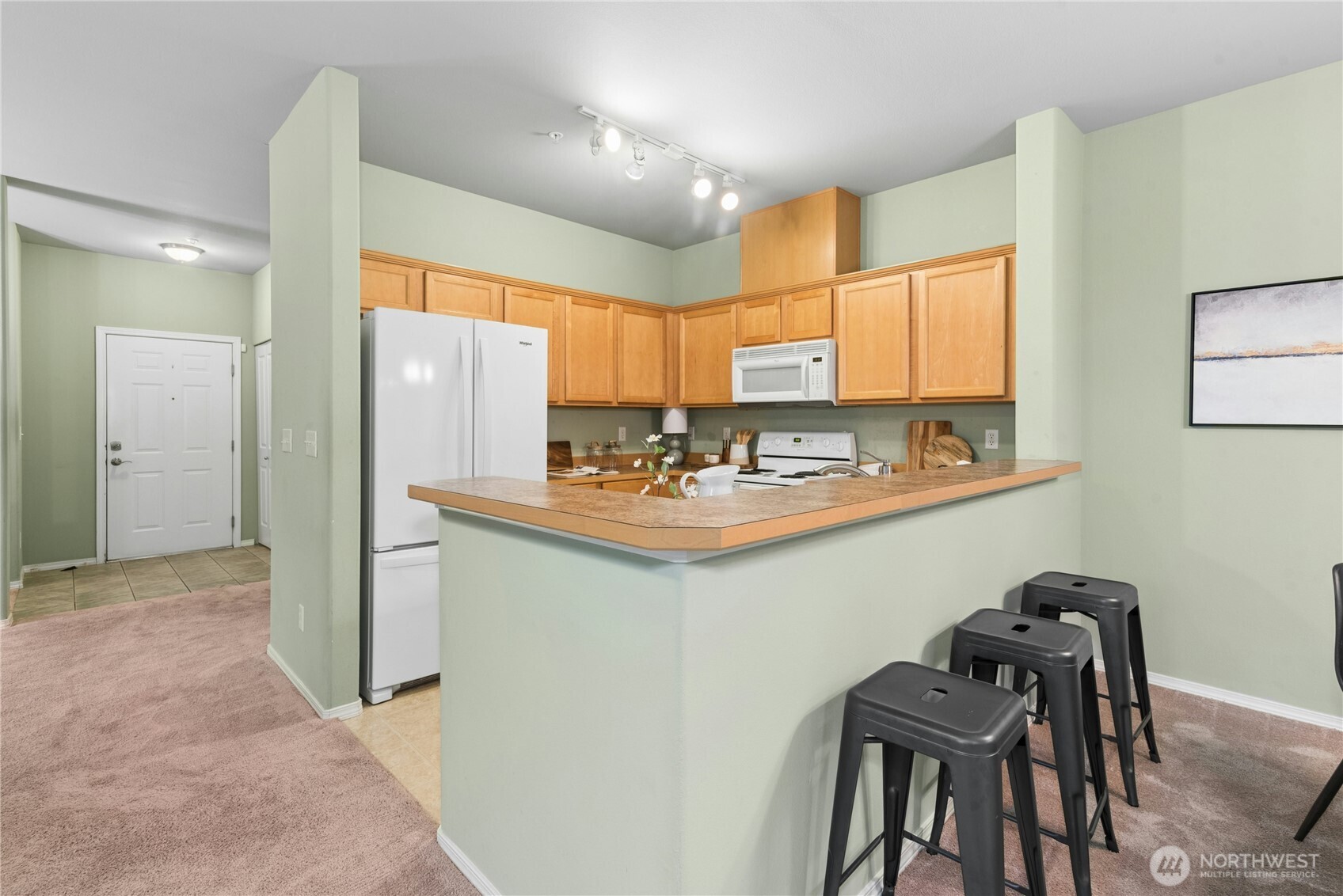 14915 38th Drive Southeast, Unit II1033 Bothell, WA 98012 - Photo 6 of 25 a kitchen with stainless steel appliances kitchen island granite countertop a sink and cabinets
